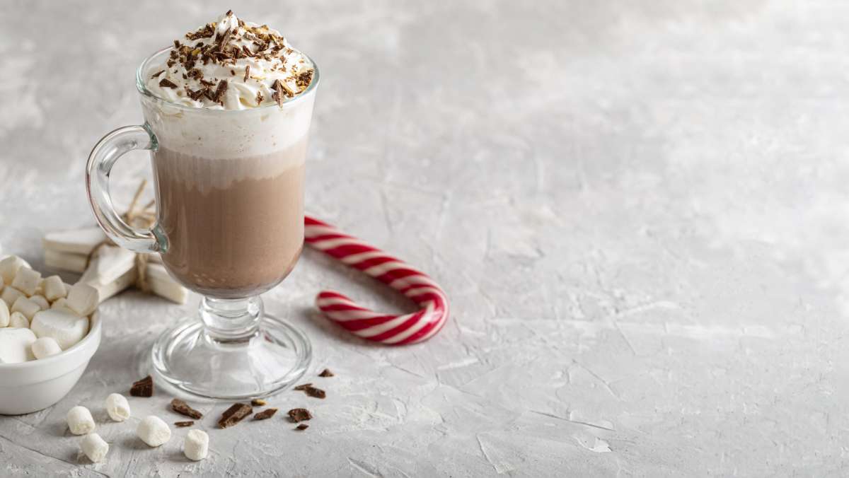Carolling with peppermint hot chocolate with whipped cream